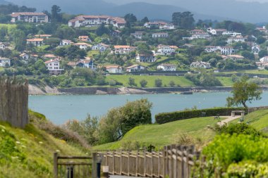 View of Saint-Jean-de-Luz fishing port on Basque coast, famous resorts, known for beautiful architecture, sandy beaches, cuisine, Santa Barbara chapel, South of France, Basque Country clipart