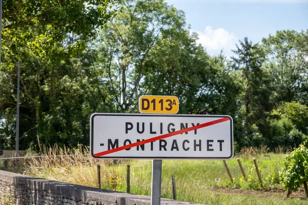 stock image Road sign Puligny-Montrachet village, wine of Burgundy France. High quality white dry wine making from Chardonnay grapes on grand cru classe vineyards and clos