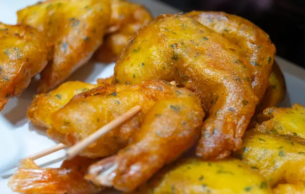 stock image Typical snacks of Basque Country, pinchos or pinxtos skewers with small pieces of bread, fish, sea food, sweet green pepper served in bar in San-Sebastian or Bilbao, Spain, close up