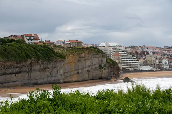 stock image Panoramic view from lighthouse on cliffs, houses, sandy beaches of touristic Biarritz city, Basque Country, Bay of Biscay of Atlantic ocean, France, storm in Biarritz