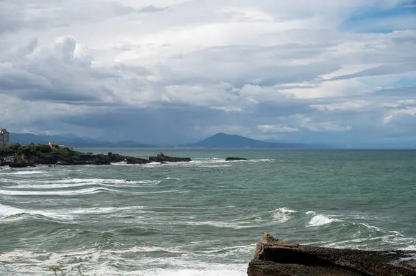 stock image Panoramic view from lighthouse on cliffs, houses, sandy beaches of touristic Biarritz city, Basque Country, Bay of Biscay of Atlantic ocean, France, storm in Biarritz