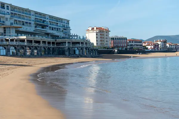 stock image Sandy beach and houses of Saint Jean de Luz town on Basque coast, famous resort, known for beautiful architecture, nature and cuisine, South of France, Basque Country