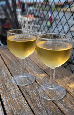 Tasting of Bordeaux white wine, France. Glasses of white sweet French wine served in outdoor restaurant, oysters farm in Gujan-Mestras, Arcachon bay clipart