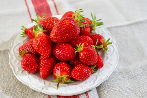 Stock image New season of berrues, plate with french organic red ripe sweet strawberries Fraises de Plougastel, harvested in France