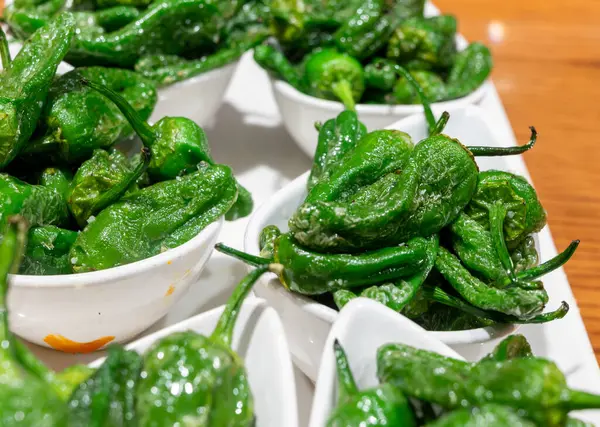 stock image Typical snacks of Basque Country, pinchos or pinxtos skewers with small pieces of bread, fish, sea food, sweet green pepper served in bar in San-Sebastian or Bilbao, Spain, close up