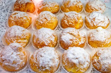 Many Chouquettes or petits choux are small pieces French patisserie consisting of small spheres of choux pastry, sugared and baked, Bordeaux, France clipart