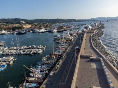 Aerial view on boats, yachts and old port of famous Saint-Tropez town at sunset on French Riviera, Var, Provence, France, summer vacation destination clipart