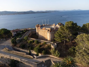 Aerial view on bay, hills,, old citadel fort, olorful houses of famous Saint-Tropez town on French Riviera at sunset, Var, Provence, France, summer vacation destination clipart