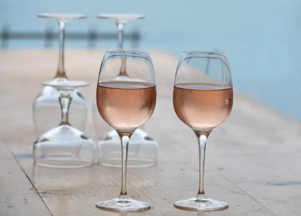 stock image Summer time in Provence, two glasses of cold rose wine with blue sea view on background, French Riviera near Menton and Monaco, south of France