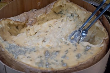 Italian food, buttery and soft blue cheese made from cow milk in Gorgonzola, Milan, Italy in large wooden box on Italian farmers market clipart