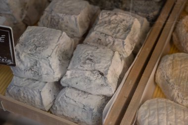 Cheese collection, French Carre Cendre Lait cru Chevre pyramid cheese made from goat milk with ash in Souillac, Perigord region in France close up clipart