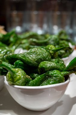 Typical snacks of Basque Country, pinchos or pinxtos skewers with small pieces of bread, fish, sea food, sweet green pepper served in bar in San-Sebastian or Bilbao, Spain, close up clipart