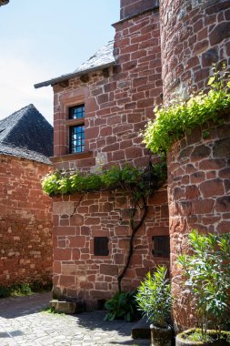 Collonges-la-Rouge village one of the most beautiful villages in France with houses made from red stones, tourists destination in Dordogne clipart