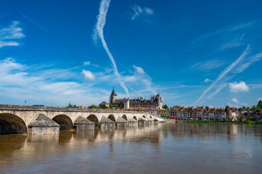 Views of old part of town of Gien on the Loire river, in Loiret department, France, houses with tiled roofs and chimneys, castle and bridge clipart