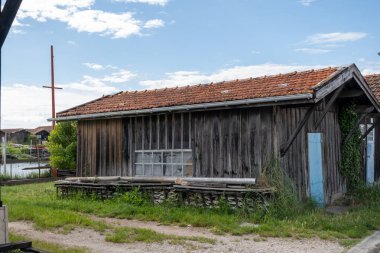 Travelling in France, old wooden huts and oysters farms in Gujan-Mestras village, cultivation, fishing and sale of fresh oysters seashells, Arcachon bay, Atlantic ocean, France, tourists destination clipart