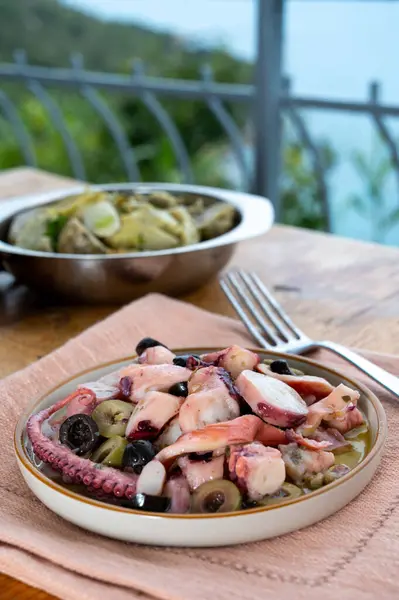 stock image Tasty antipasti salad or starter seafood dish, grilled octopus ligurian style with green and black olives served in Italian  restaurant