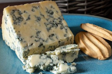 Cheese collection, English cow milk semi-soft, crumbly old stilton blue cheese close up clipart