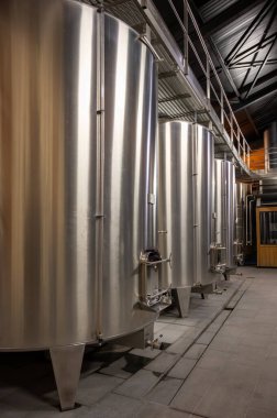 Steel tanks for first fermentation of grapes on winery, Saint-Emilion wine making region picking, sorting with hands and crushing Merlot or Cabernet Sauvignon red wine grapes, France clipart