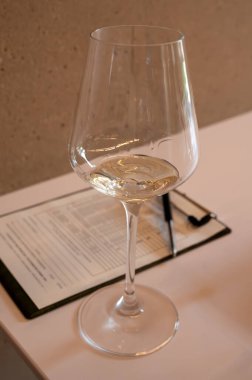 Tasting of white dry wine made on Moselle river valley in Luxembourg, winery visit in Grevenmacher, wine from terraced vineyards , close up clipart