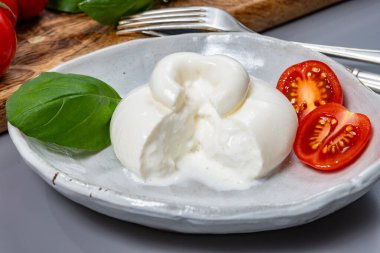 Taze İtalyan peyniri, beyaz burrata topları ya da mozzarella ve kremadan yapılmış burratina peyniri yemek.