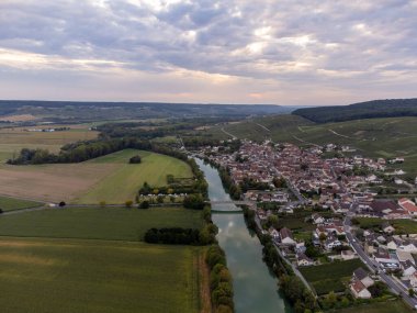 Panoramic aerial view on green premier cru champagne vineyards and fields near village Hautvillers and Cumieres and Marne river valley, Champange, France in September clipart