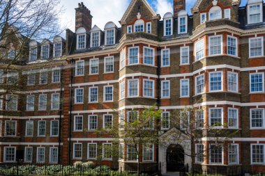 Kensington ve Chelsea Kraliyet Borough 'daki Hans Crescent caddesindeki kırmızı tuğlalı evler, Londra, İngiltere. Baharda