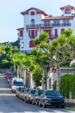 White houses and villas of Saint Jean de Luz town on Basque coast, famous resort, known for beautiful architecture, nature and cuisine, South of France, Basque Country clipart