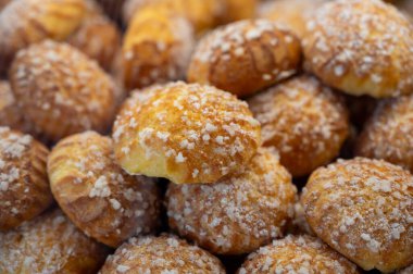 Many Chouquettes or petits choux are small pieces French patisserie consisting of small spheres of choux pastry, sugared and baked, Bordeaux, France clipart