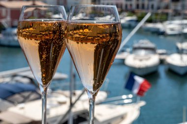 Fransız brut şampanyası şampanya köpüklü lale kadehleri ile Saint-Tropez yakınlarındaki Port Grimaud limanında, Fransız Riviera tatili, Var, Fransa yaz tatili