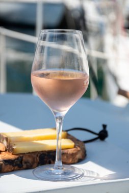 Party with cold rose wine on yacht boat anchored in port la Rague, Gulf of La Napoule, in Provence, two glasses of cold rose wine, French Riviera near Cannes, south of France clipart