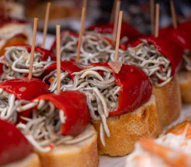 Bask ülkesinin tipik aperatifleri, küçük ekmek parçaları, deniz ürünleri, yumurta, peynir, San-Sebastian veya Bilbao, İspanya 'daki barlarda servis edilen jamon şişleriyle kapatılıyor.