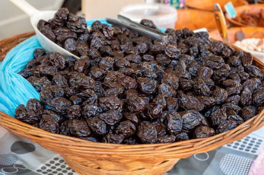 Bulk dried dehydrated black plums fruits from Agen, France on local market in Biarritz clipart