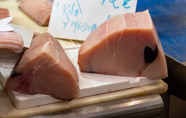 Assortment of fresh ocean daily catch of tuna, cazon, sharks, fish, prawns, seashells, molluscs on ice on fish market in Jerez de la Frontera, Andalusia, Spain clipart