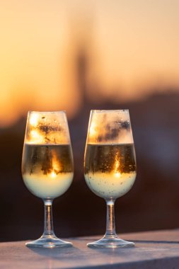 Gün batımında İspanya, Endülüs, Sevilla 'nın merkezi manzaralı açık çatı terasında kava ya da şampanya içmek.