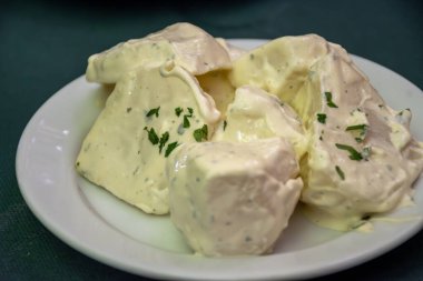 Vegetarian Spanish food, boiled potatoes with alioli sauce and parsley served as tapa in old tavern, Andalusia, Spain clipart