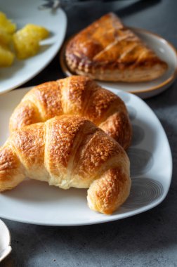 Fresh baked two buttered croissants served in restaurant for continental or French breakfast on board clipart