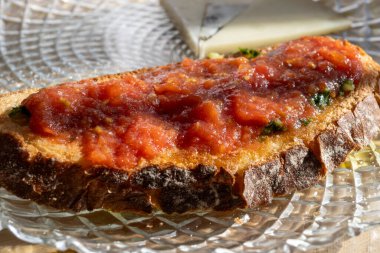 Traditional andalusian breakfast on roof patio with bread toasts, fresh ground tomatoes sauce and olive oil, Sevilla, Andalusia, south of Spain clipart