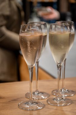 Tasting of sparkling white wine, traditional champagne method making of cremant in caves on Moselle river valley in Luxembourg, wine tour and visiting caves clipart