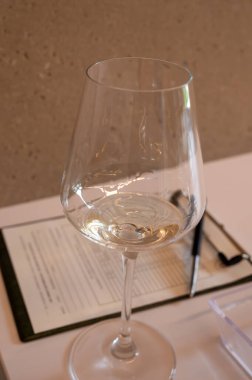 Tasting of white dry wine made on Moselle river valley in Luxembourg, winery visit in Grevenmacher, wine from terraced vineyards , close up clipart