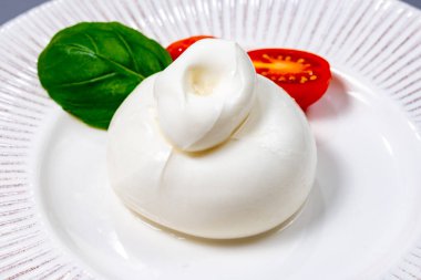 Taze İtalyan peyniri, beyaz burrata topları ya da mozzarella ve kremadan yapılmış burratina peyniri yemek.