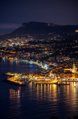 Fransız Rivierası 'nda gece manzarası, Menton' un eski şehir ışıkları ve mavi Akdeniz 'de Fransız-İtalyan sınırı, Monaco, Monte-Carlo, seyahat yeri, panoramik deniz manzarası