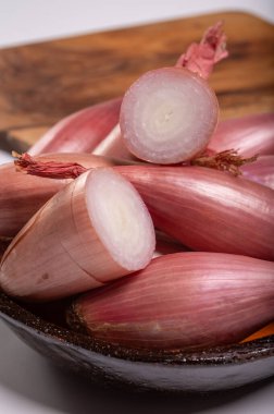 French long purple eschalot onions vegetables in bowl clipart