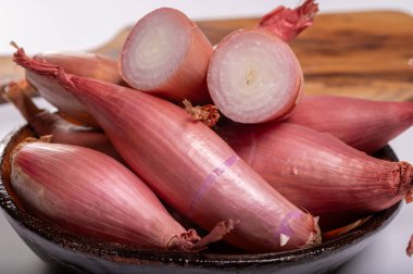 French long purple eschalot onions vegetables in bowl clipart