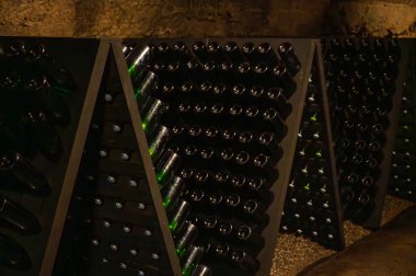 Riddling manual process in caves, wooden pupitres, traditional method of production of cremant sparkling wine in south part of Luxembourg country on bank of Moezel, Mosel river. Wine tour. clipart