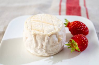 Cheese collection, soft sheeps milk brebis French cheese with mold produced on cheese farm in Basque Country in France and fresh strawberry clipart