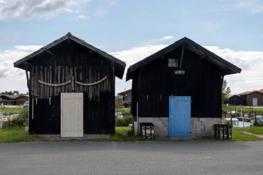 Travelling in France, old wooden huts and oysters farms in Gujan-Mestras village, cultivation, fishing and sale of fresh oysters seashells, Arcachon bay, Atlantic ocean, France, tourists destination clipart