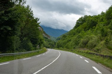 Driving car or camper on free road Route Napoleon in French Alps, touristic road in France, views from road clipart