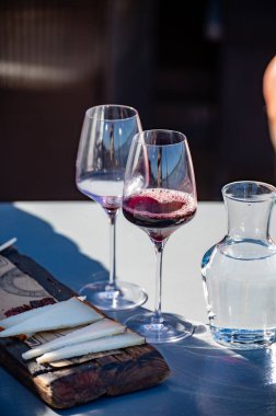 Wine making on bodegas wineries on volcanic soils of Mount Teide in Tacoronte-Acentejo wine region on Tenerife, Canary islands vacation, Spain, tasting of red listan negro grape dry wine with local cheese clipart