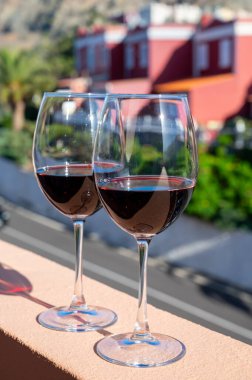 Wine making on bodegas wineries on volcanic soils of Mount Teide in Ycoden-Daute-Isora wine region on Tenerife, Canary islands winter sun vacation, Spain, red wine glasses outdoor clipart