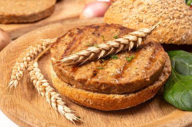 Vejetaryen veya vejetaryen köftelerden hamburgerler yapmak veya tahıldan yapılmış hamburgerler, hayati buğday glüten yemekleri, ızgara sağlıklı yiyecekler.